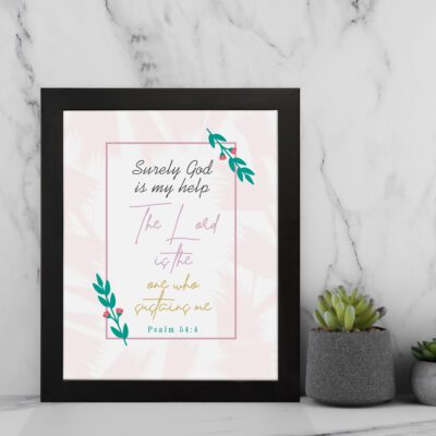 Psalm 54:4 Bible verse wall art with simple fonts, pink highlights, leafy decorations, and a light background. displayed on the wall in a black frame