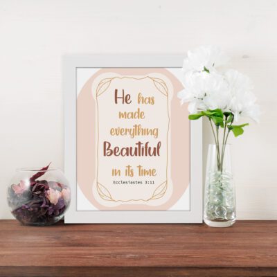 He Has Made Everything Beautiful In Its Time Ecclesiastes 3:11 Bible Wall Art with light peach background and elegant font design. displayed on the table in a white frame