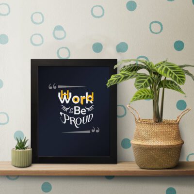 Infidu Work Hard Be Proud - Inspirational & Motivational Quotes Wall Art with a bold navy blue background, perfect for home or office decor. displayed on the table in a black frame