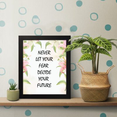 Infidu Never Let Your Fear Decide Your Future - Inspirational & Motivational Quotes Wall Art with bold black text for home or office decor. displayed on the table in a black frame
