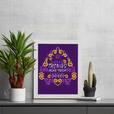 Motivational wall art featuring the quote Great things come from comfort zones in white and pink text with golden-yellow and pink patterns on a dark purple background. displayed on the table in a white frame