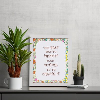 Infidu The Best Way to Predict Your Future Is to Create It - Inspirational & Motivational Quotes Wall Art with bold brown text for home or office decor. displayed on the table in a white frame