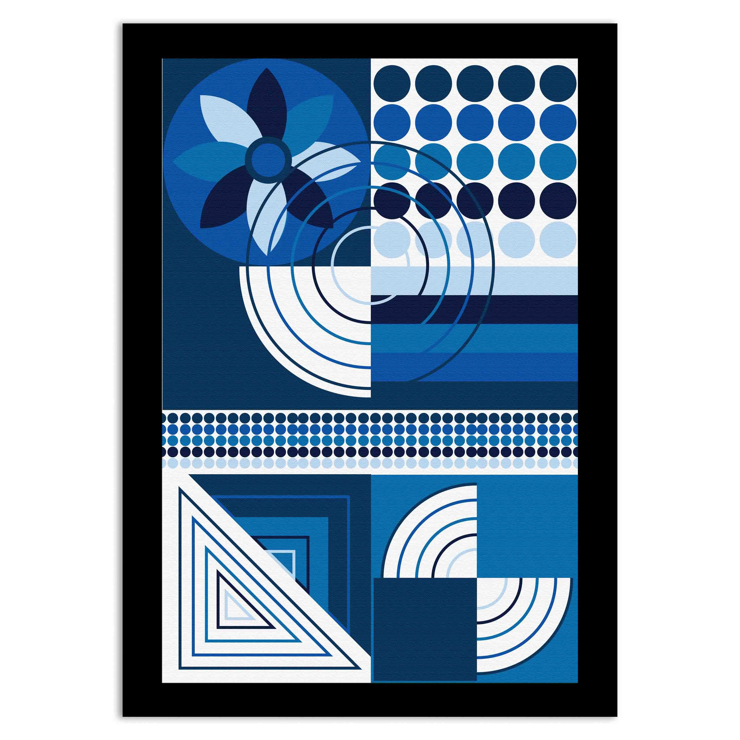 Abstract wall art with geometric shapes in blue, white, and black, framed in black, displayed on a light gray wall in a cozy setting.