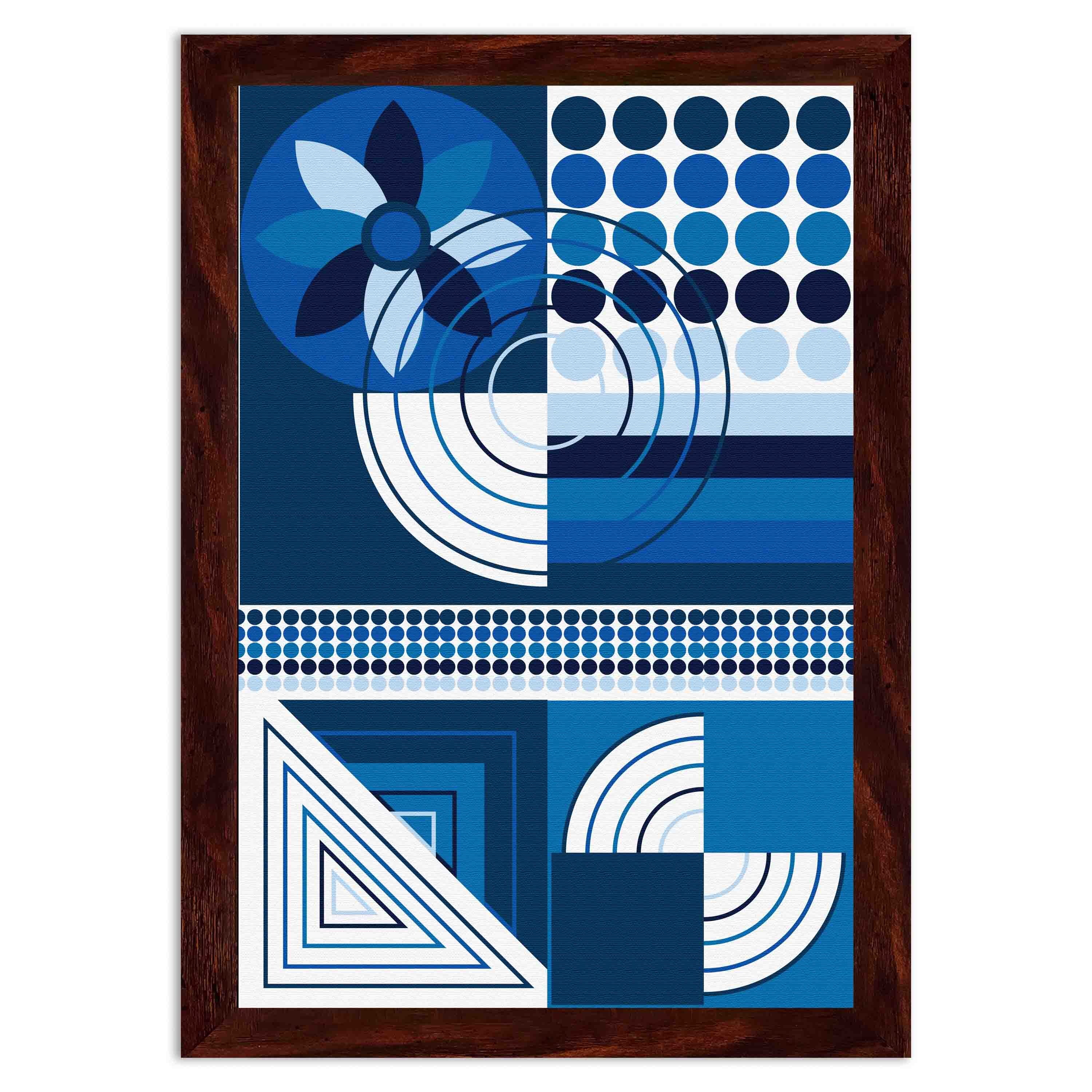 Abstract wall art with geometric shapes in blue, white, and black, framed in black, displayed on a light gray wall in a cozy setting.