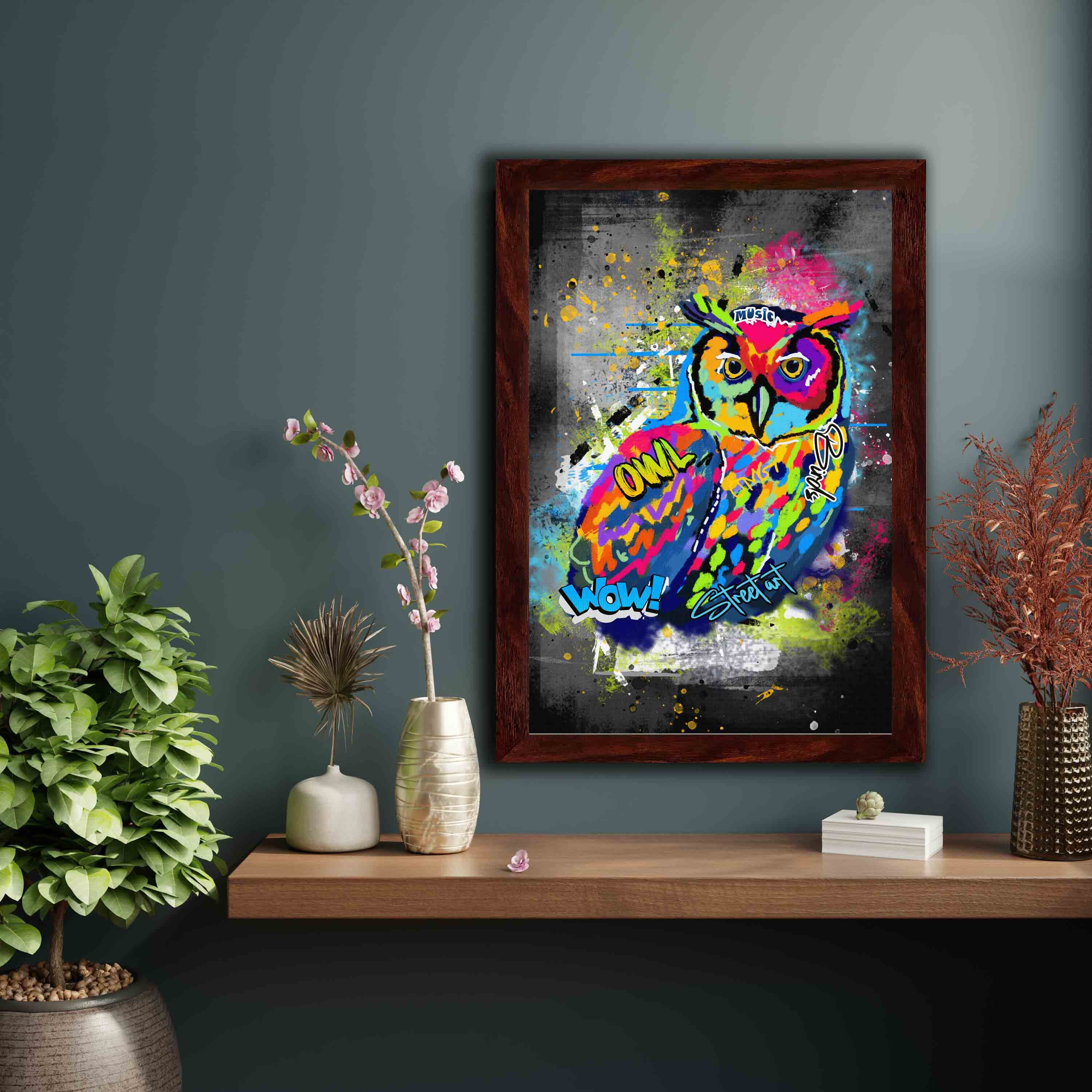 Graffiti-style wall art featuring a colorful owl with bright shades of blue, yellow, red, pink, and green on a dark, edgy background.