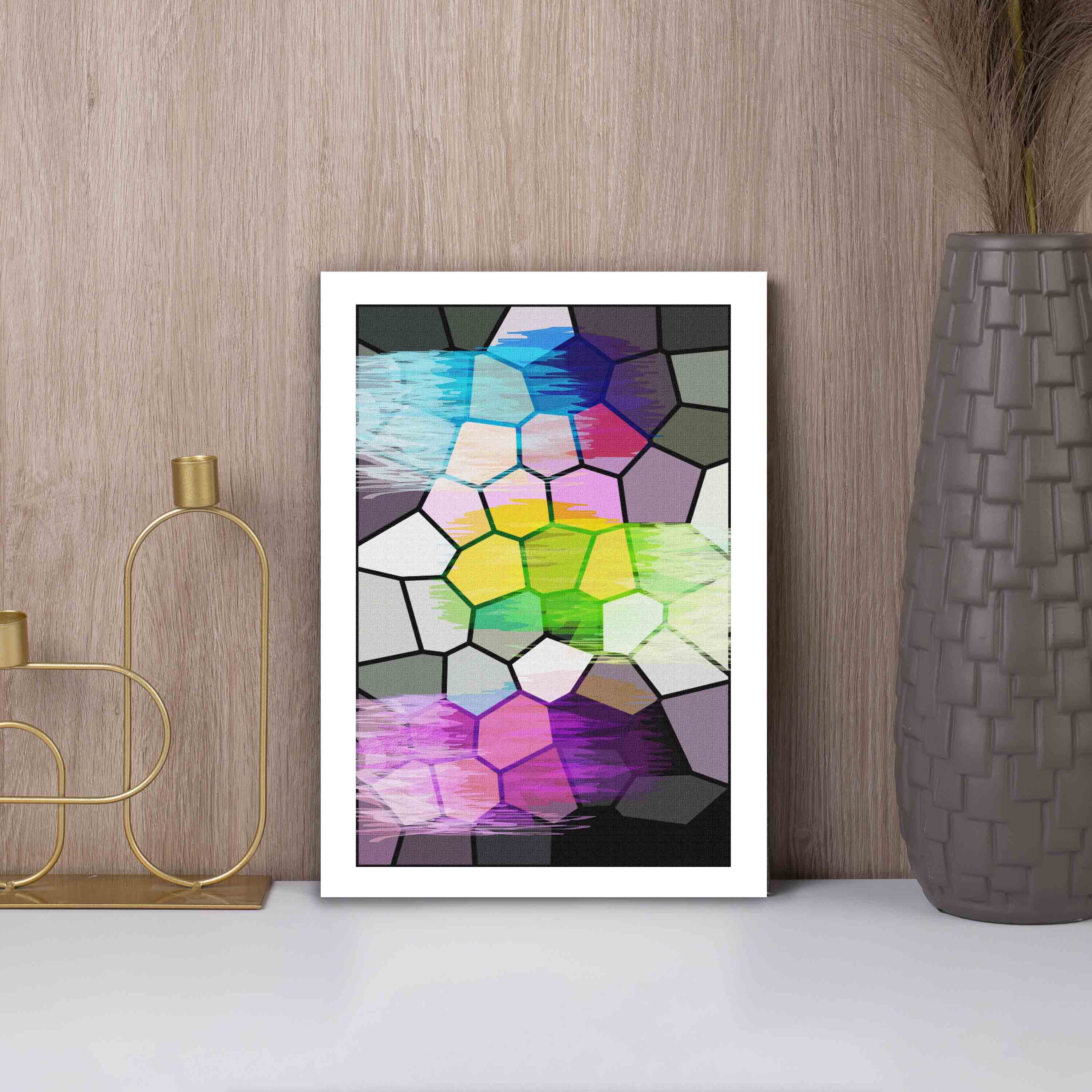 Abstract wall art with a stained glass-style mosaic design in shades of blue, purple, green, pink, yellow, and gray, framed in white.