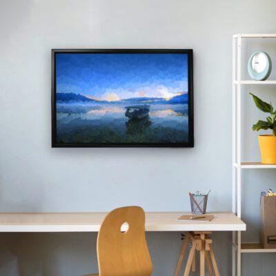 The scenic wall art of a boat floating on calm waters with a blue sky and mountains in the background is framed and set against a light gray wall.