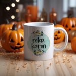 White coffee mug with "Relax Karen" in black casual font inside a light blue-green watercolor circle, decorated with small flowers. A microwave-friendly espresso cup.