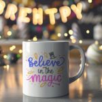 White coffee mug with Believe in the Magic in blue, black, and pink, decorated with a magician's hat and colorful elements. A microwave-friendly espresso cup.