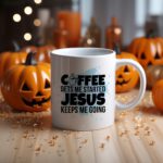 White coffee mug with "Coffee Gets Me Started, Jesus Keeps Me Going" in bold black and blue text, a coffee cup icon, and a light blue splash effect.