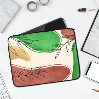 Infidu Modern Abstract Laptop Sleeve with overlapping shapes and simple black line-drawn leaves in green, pink, beige, and white. laptop sleeve kept on a plain white background