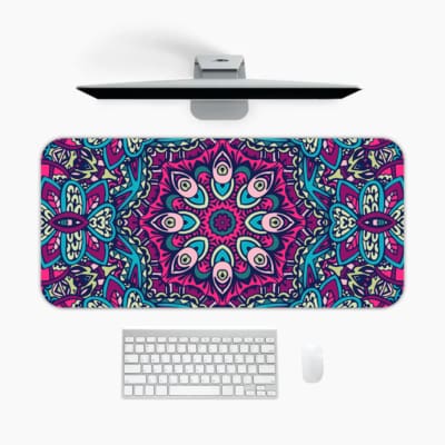Infidu Colorful Mandala Design Desk Pad with intricate patterns in pink, blue, purple, and teal, plus white and black accents. A desk pad under the computer
