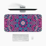 Infidu Colorful Mandala Desk Pad featuring a vivid mandala pattern with symmetrical shapes in pink, purple, and blue tones. A desk pad under the computer