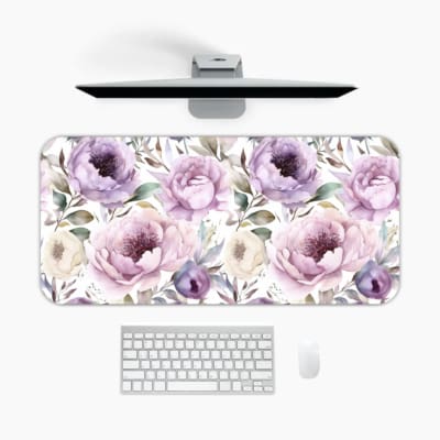 Infidu Flowers Design Desk Pad with green leaves and large purple and pink flowers on a light, neutral background. A desk pad under the computer