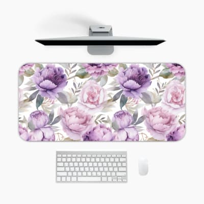 Infidu Floral Desk Pad featuring purple and light pink flowers with green and grayish leaves on a light white background. A desk pad under the computer