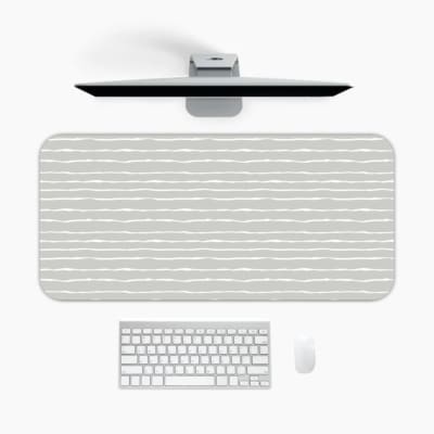 Infidu Light Gray Desk Mat with a subtle color effect, featuring a soft, monochromatic gray background with no prominent patterns. A desk pad under the computer