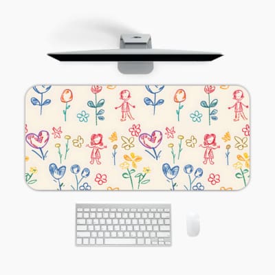 Desk pad with childlike drawings of flowers, stick figures, and hearts in pastel blue, pink, and yellow. A desk pad under the computer