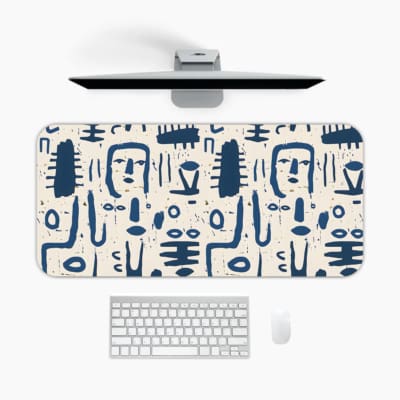 Blue tribal symbols desk pad with abstract patterns on a dim white background. A desk pad under the computer