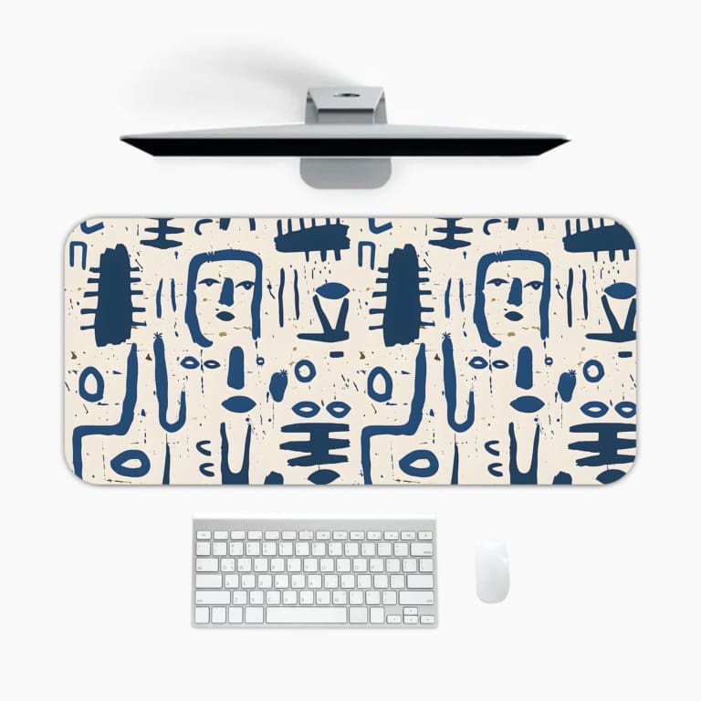 Blue tribal symbols desk pad with abstract patterns on a dim white background. A desk pad under the computer