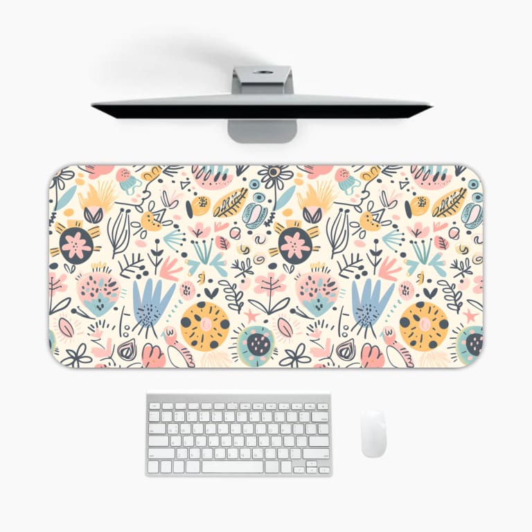 Infidu desk pad with soft pastel floral design on a light pink background, featuring delicate light blue, pink, and beige flowers. A desk pad under the computer