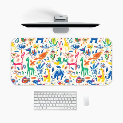 Bright desk mat featuring colorful animals, plants, and abstract shapes on a white background. A desk pad under the computer