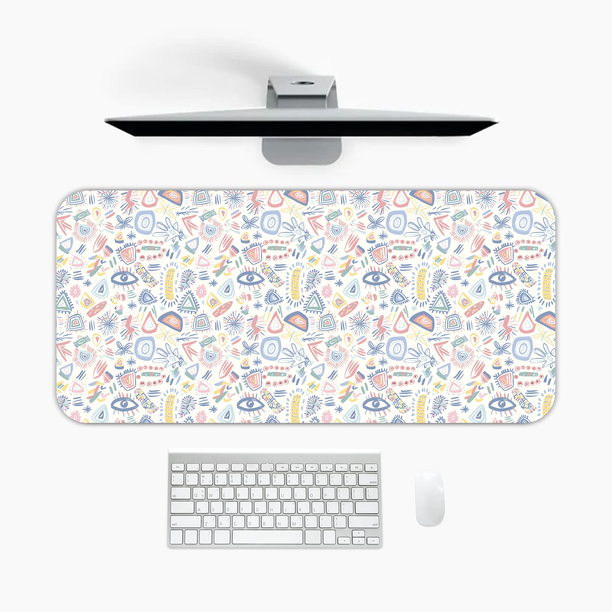 Infidu Playful Abstract Shapes Desk Pad featuring colorful eyes, symbols, and shapes on a light background. A desk pad under the computer