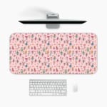 Infidu Pink Floral Pattern Desk Pad with colorful flowers on a vibrant pink background. A desk pad under the computer