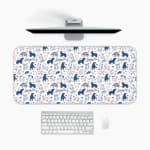 Desk pad with playful blue and dark blue bear patterns on a white background. A desk pad under the computer