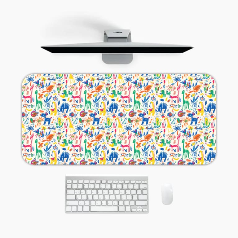 Desk pad with playful, colorful drawings of animals and plants on a white background. A desk pad under the computer