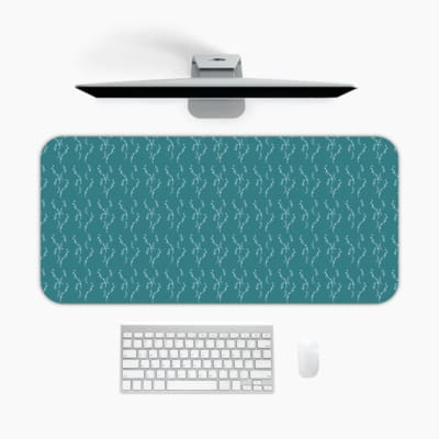 Desk pad with a green background and white ripple design, resembling water-like waves. A desk pad under the computer