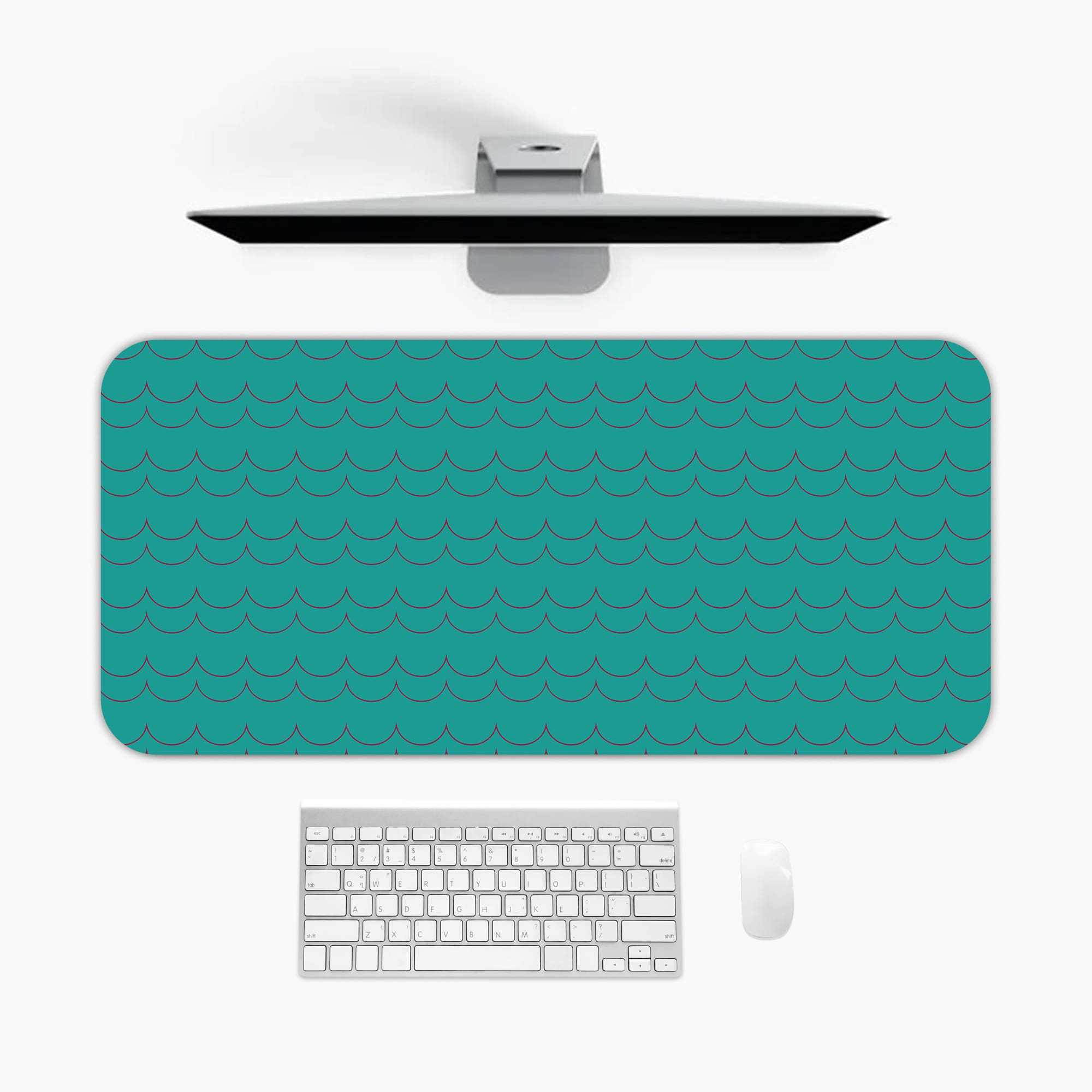 Desk pad with a turquoise green background and a subtle pattern. A desk pad under the computer