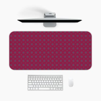 Pink desk pad with a pattern of small dots. A desk pad under the computer