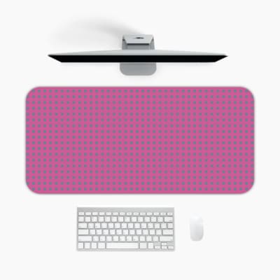 Pink desk pad with a pattern of small dots. A desk pad under the computer