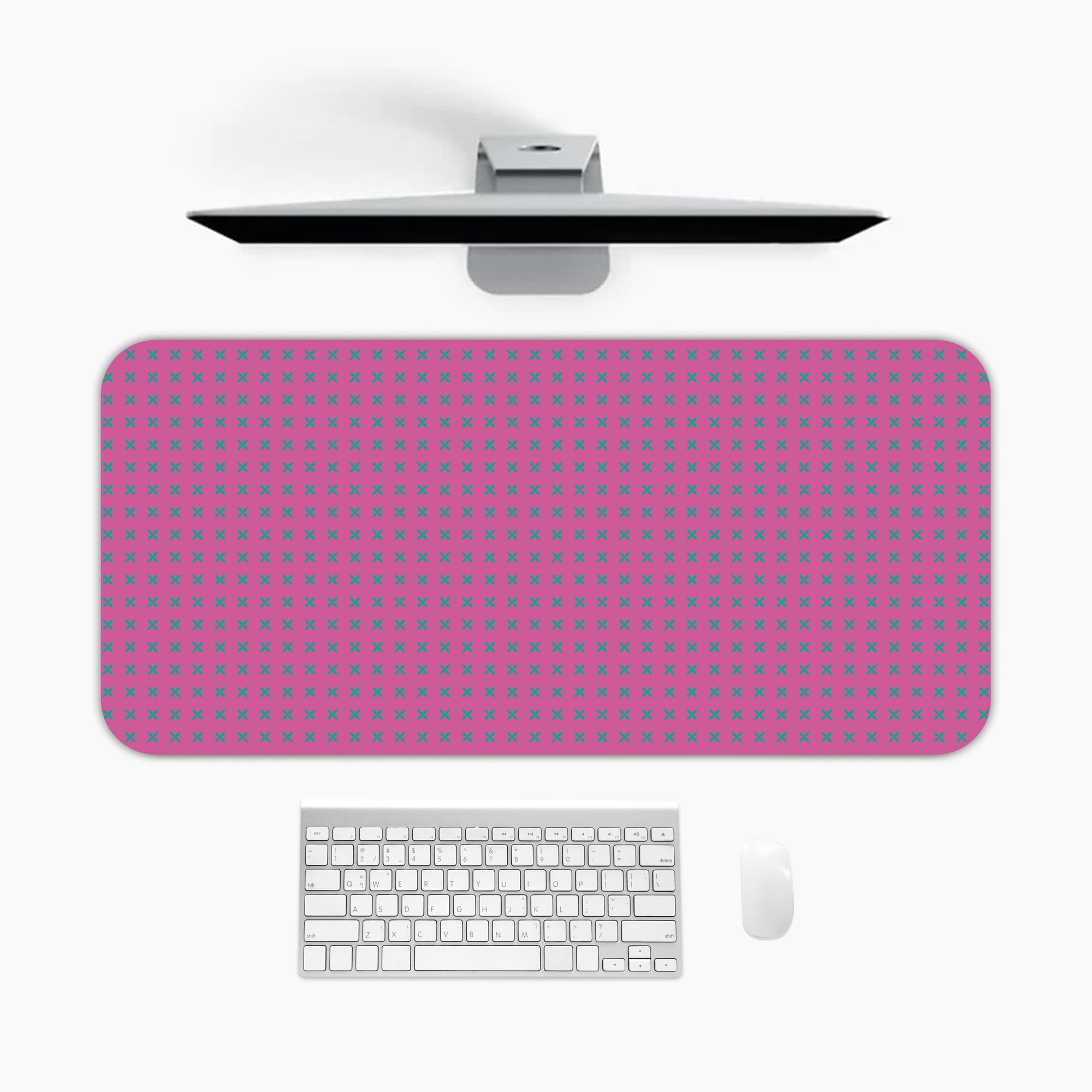 Pink desk pad with a pattern of small dots. A desk pad under the computer