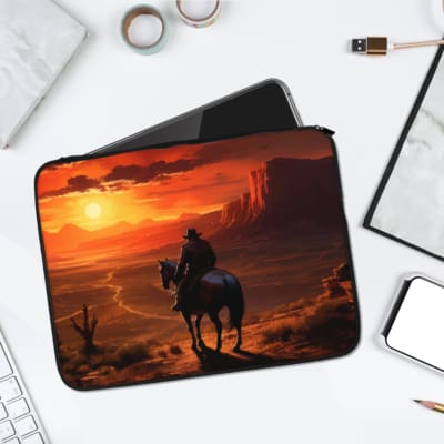 Infidu Sunset Cowboy Laptop Sleeve with a bold Western desert sunset design, featuring a cowboy on horseback. laptop sleeve kept on a plain white background