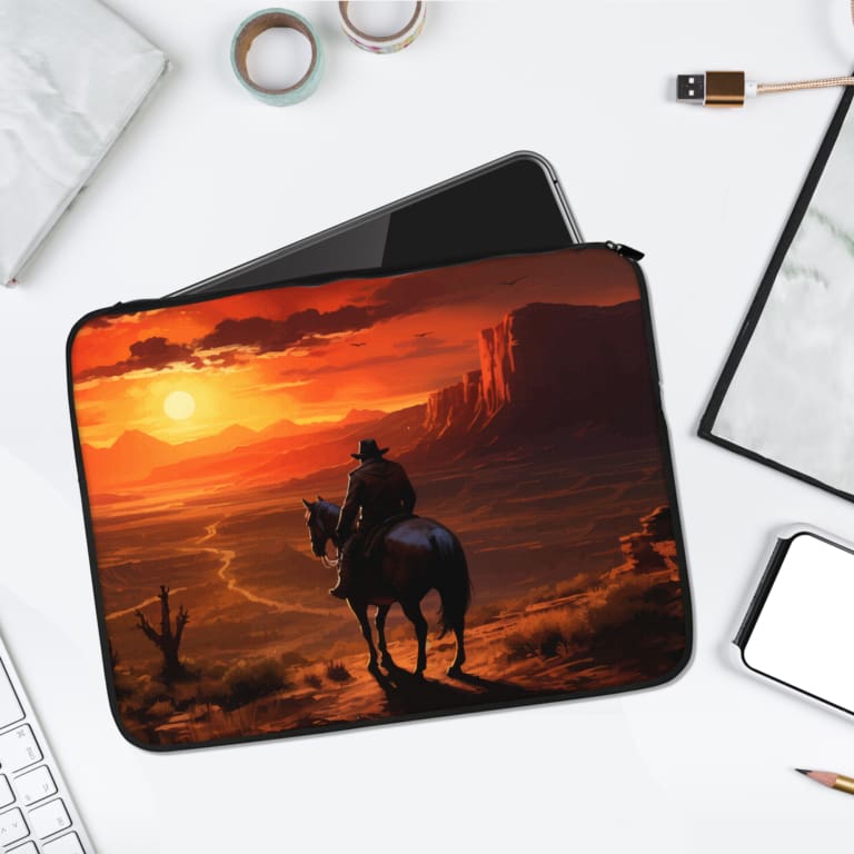 Infidu Sunset Cowboy Laptop Sleeve with a bold Western desert sunset design, featuring a cowboy on horseback. laptop sleeve kept on a plain white background