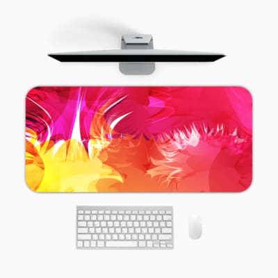 Desk pad with a vibrant pink and yellow abstract design. A desk pad under the computer