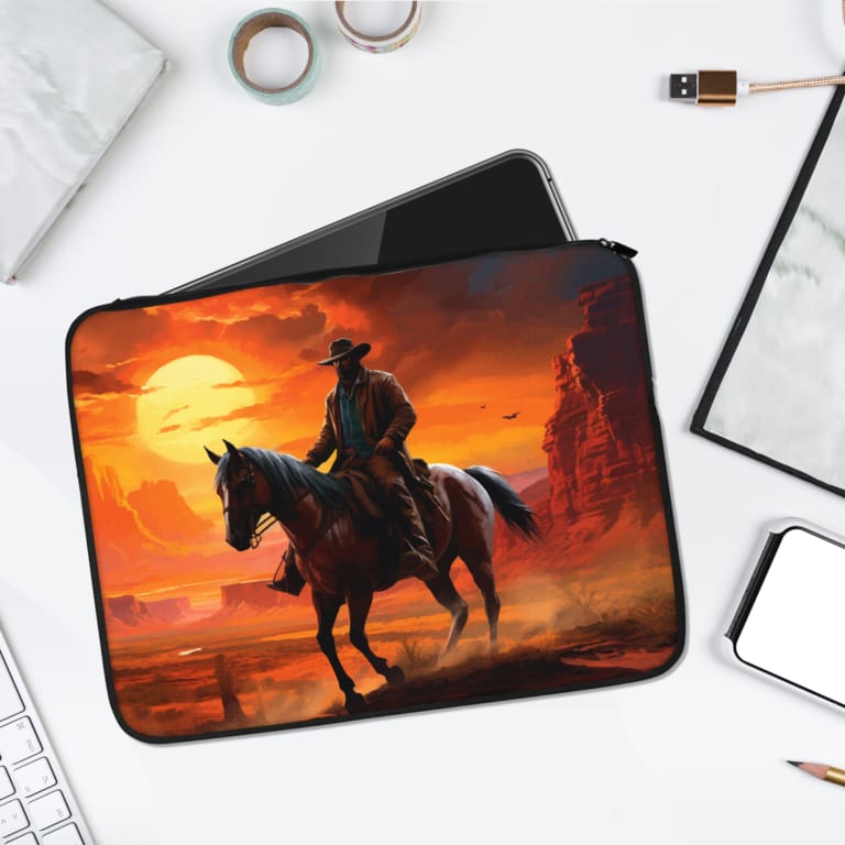 Infidu Cowboy Sunset Laptop Sleeve with a cowboy on horseback during a vibrant sunset, featuring orange, red, and yellow tones. laptop sleeve kept on a plain white background