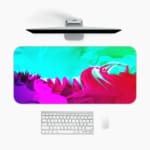 Infidu Vibrant Green and Pink Gradient Desk Pad with wave-like patterns in green, pink, and purple A desk pad under the computer