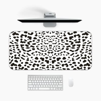 Infidu Black Leopard Print Desk Pad features a bold black leopard print pattern on a white background, offering a modern and stylish look. A desk pad under the computer