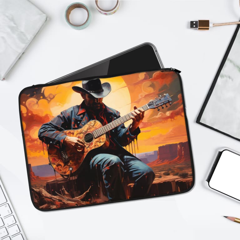 Cowboy playing guitar during a vibrant sunset with shades of orange, red, and yellow, on a laptop sleeve design. laptop sleeve kept on a plain white background