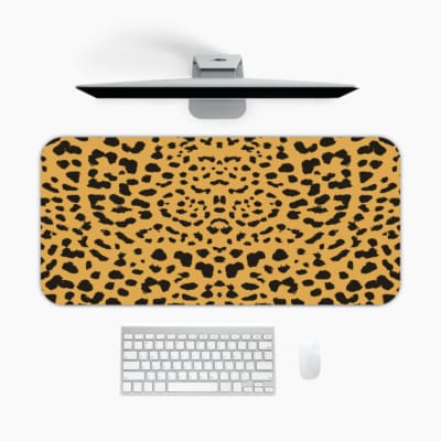 Infidu Leopard Print Desk Pad features a leopard print pattern with a tan background and black spots, resembling natural leopard fur. A desk pad under the computer