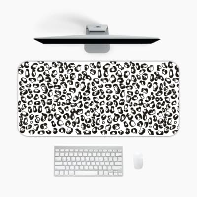 Infidu Black Leopard Print Desk Pad features a bold black leopard print pattern on a white background, offering a modern and stylish look. A desk pad under the computer
