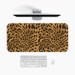 Infidu Leopard Print Desk Pad features a leopard print pattern with a brown background and black spots, resembling natural leopard fur. A desk pad under the computer