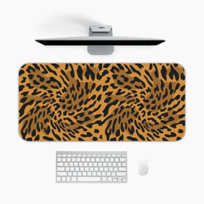 Infidu Leopard Print Desk Pad features a leopard print pattern with a brown background and black spots, resembling natural leopard fur. A desk pad under the computer