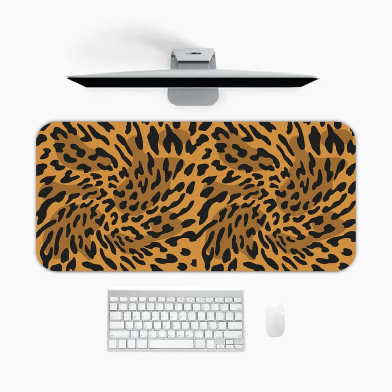 Infidu Leopard Print Desk Pad features a leopard print pattern with a brown background and black spots, resembling natural leopard fur. A desk pad under the computer