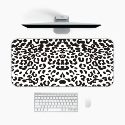 Infidu White Leopard Print Desk Pad features black spots on a white background, creating a classic and stylish leopard print design. A desk pad under the computer