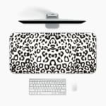 Infidu White Leopard Print Desk Pad features black spots on a white background, creating a classic and stylish leopard print design A desk pad under the computer