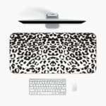 Infidu White Leopard Print Desk Pad features black spots on a white background, creating a classic and stylish leopard print design A desk pad under the computer