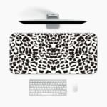 Infidu White Desk Pad with black spotted leopard print design on a white background, adding a chic touch. A desk pad under the computer